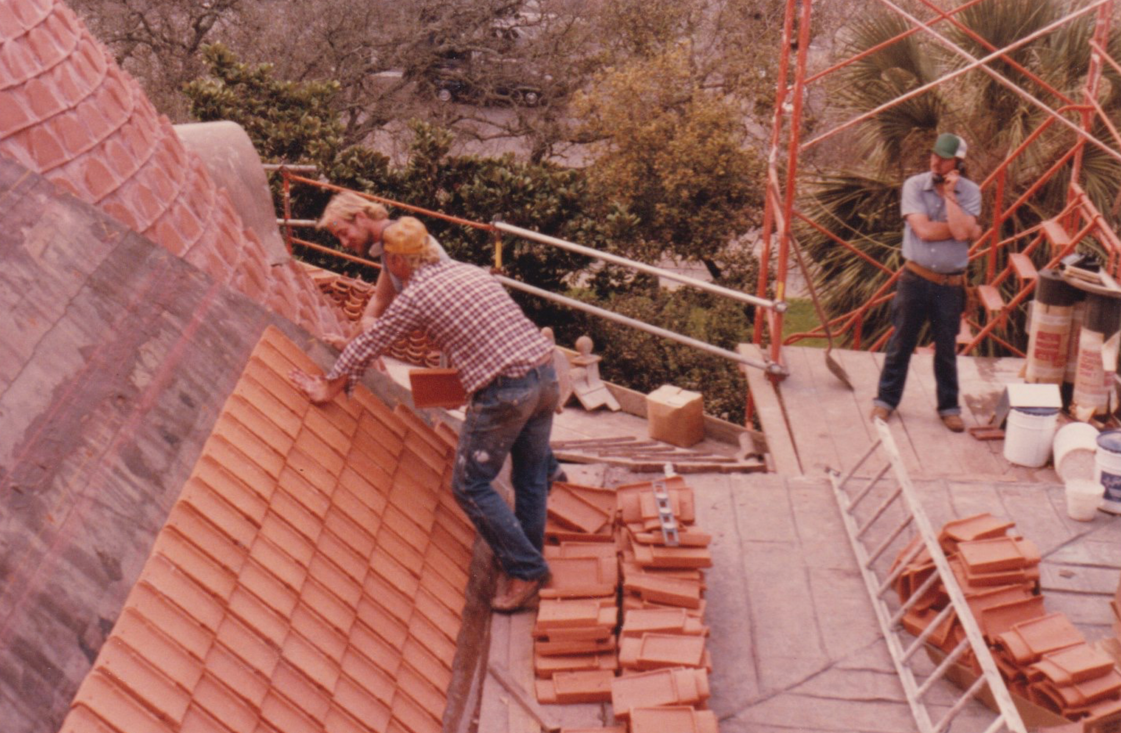 Laying clay tiles by hand with scaffolding