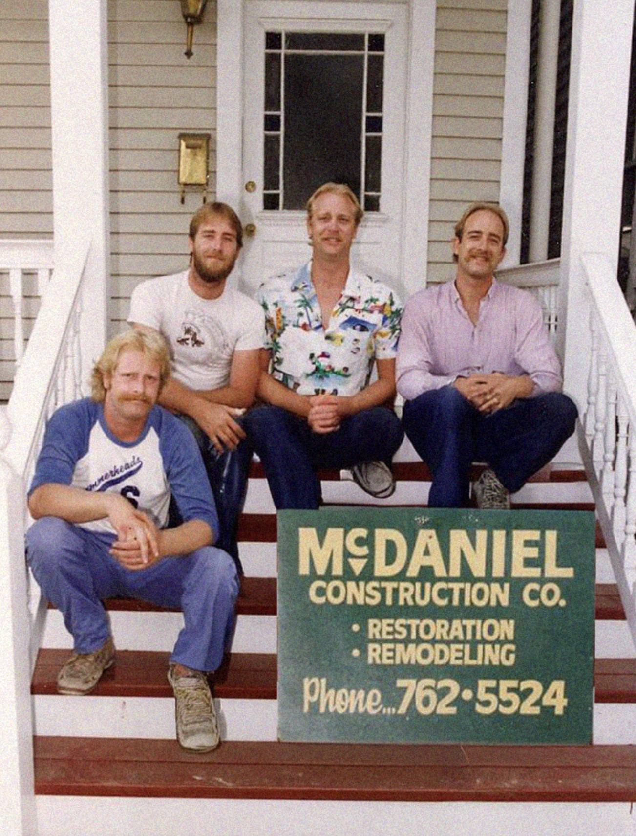 The McDaniel crew on the porch with the company sign