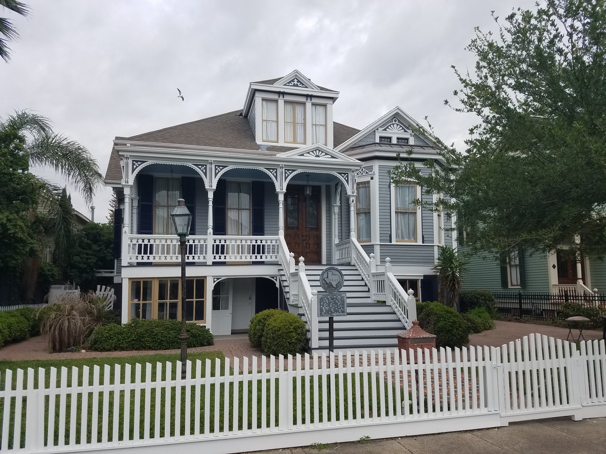 Blue Victorian home with white picket fence