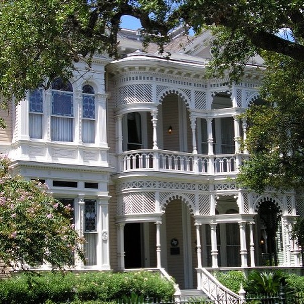 Victorian mansion with double-story wraparound porches