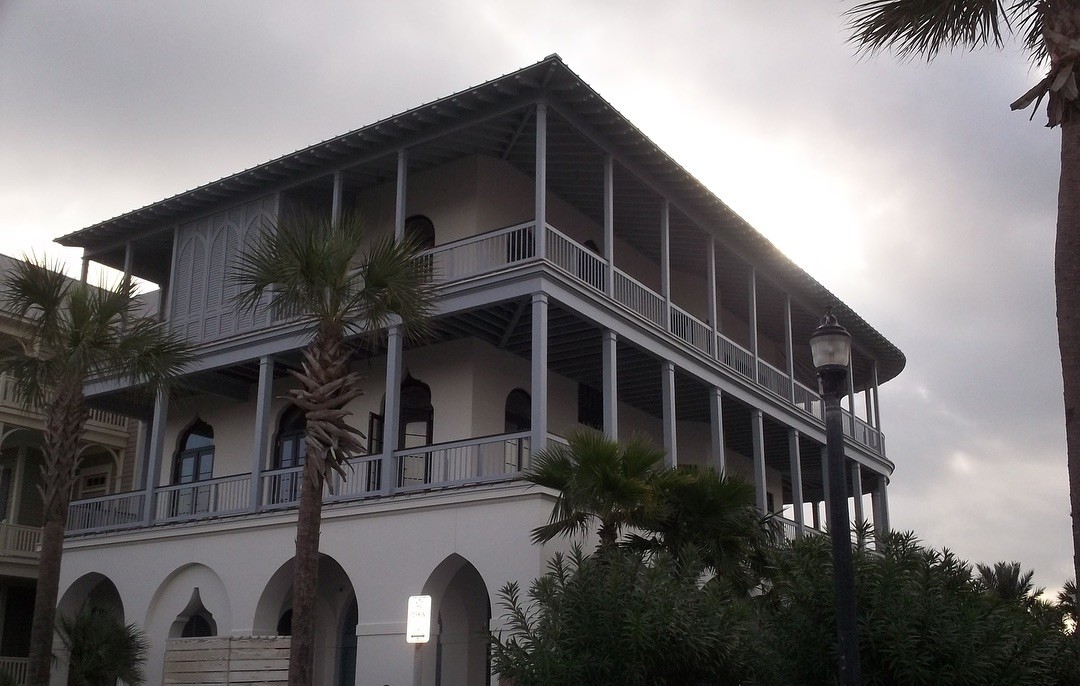 Historic building with arched galleries and landscaping