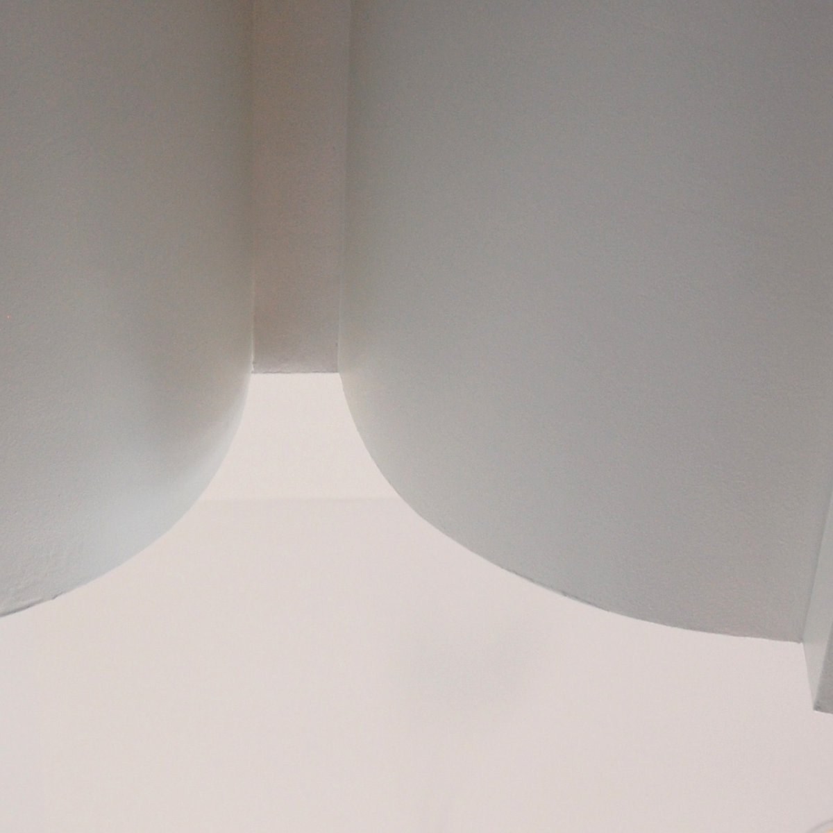 Curved white plaster archway with flowing lines