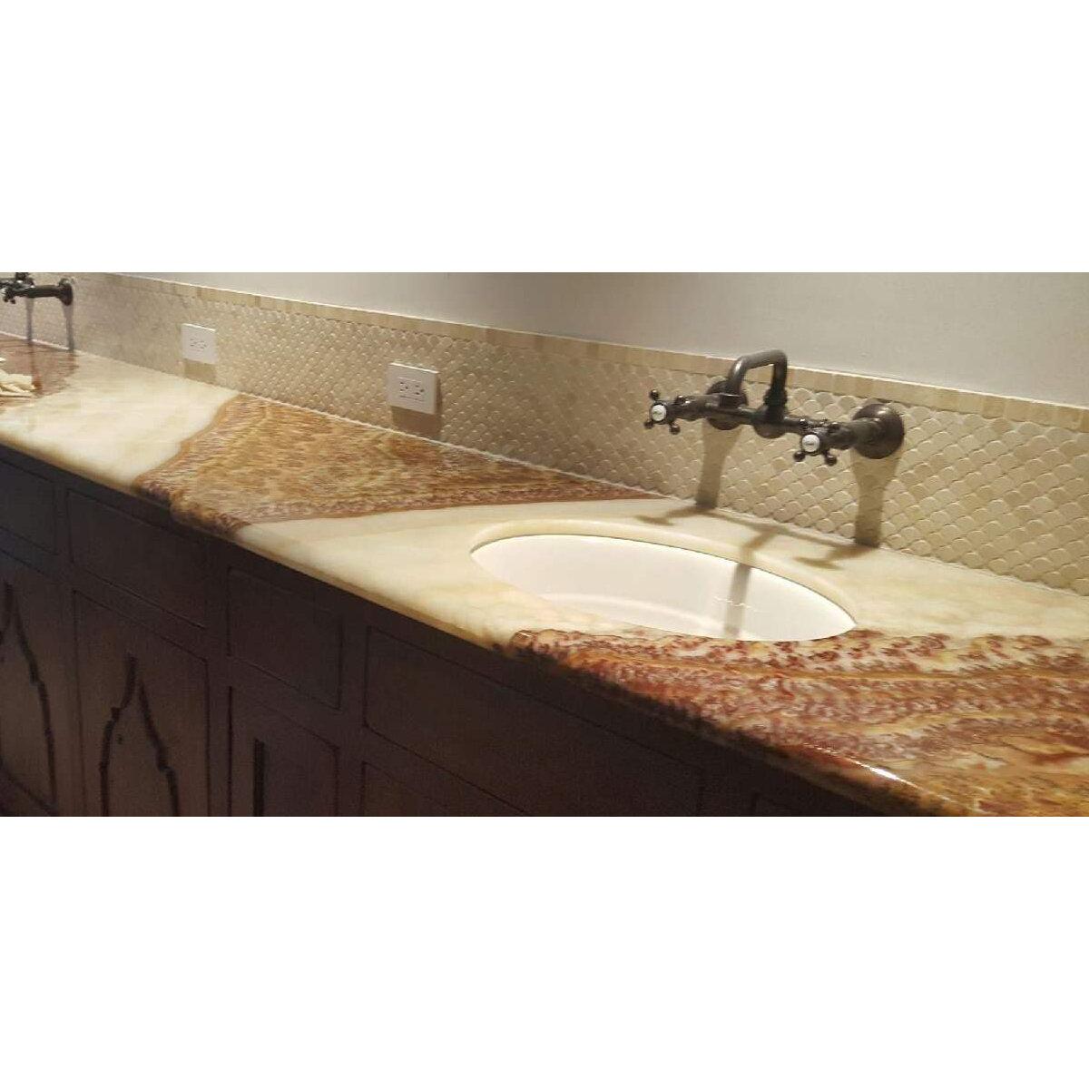 Bathroom vanity with brown granite and metallic backsplash