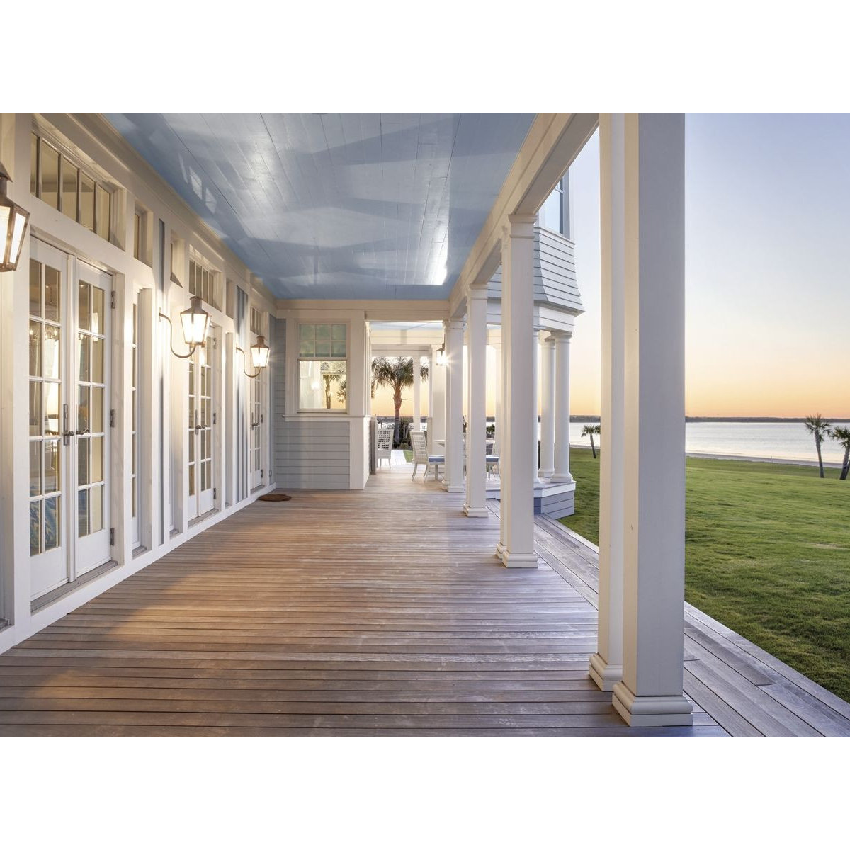 Coastal covered porch with blue ceiling and French doors