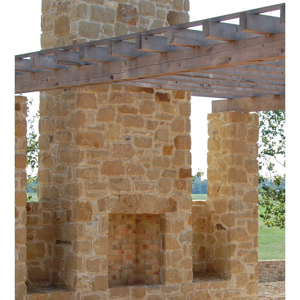 Stone fireplace with pergola structure