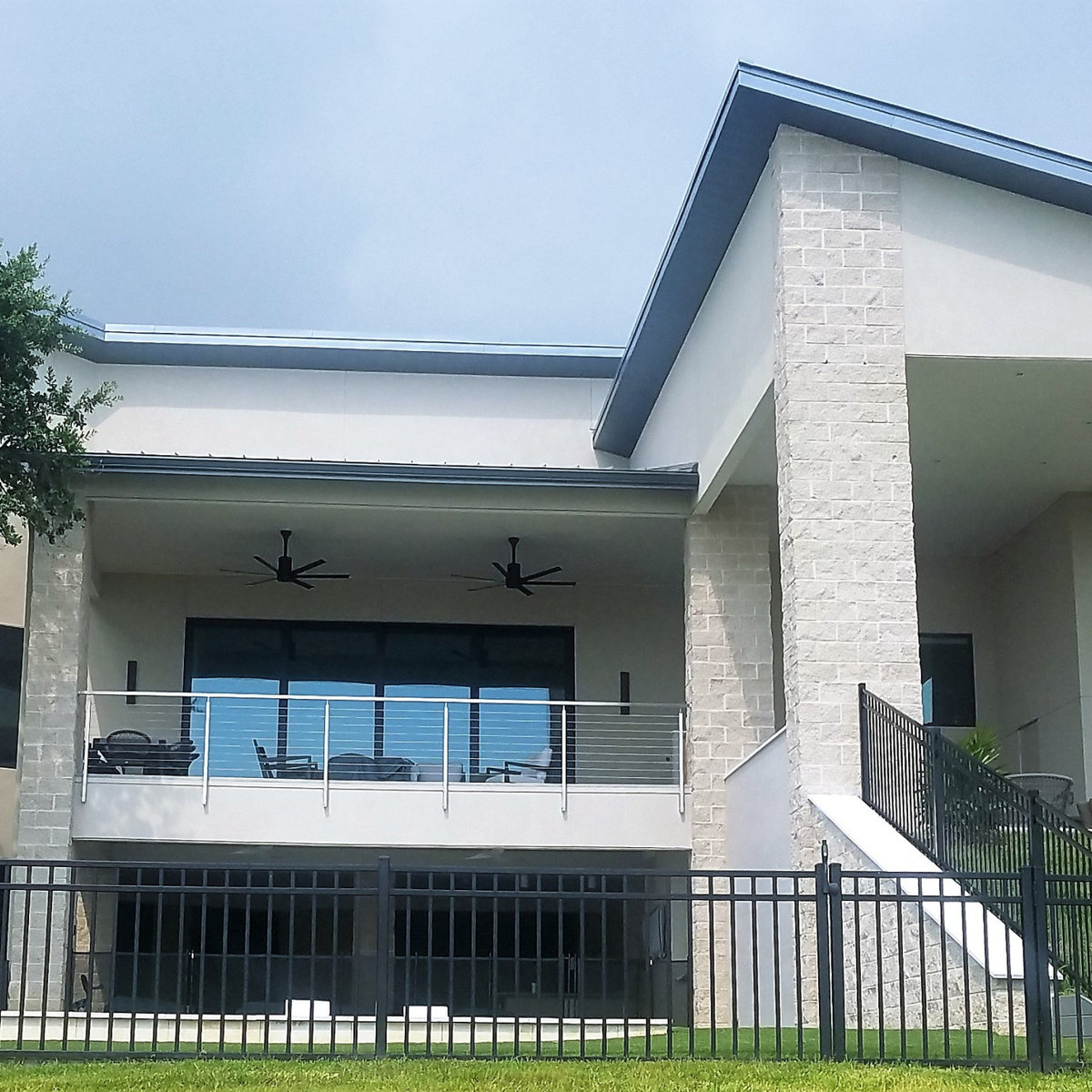 Waterfront porch with white columns and coastal views