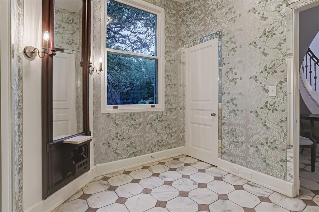 Bathroom with floral wallpaper and marble hex floor