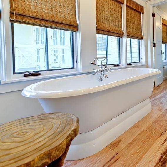 Luxury bathroom with freestanding tub and hardwood floors