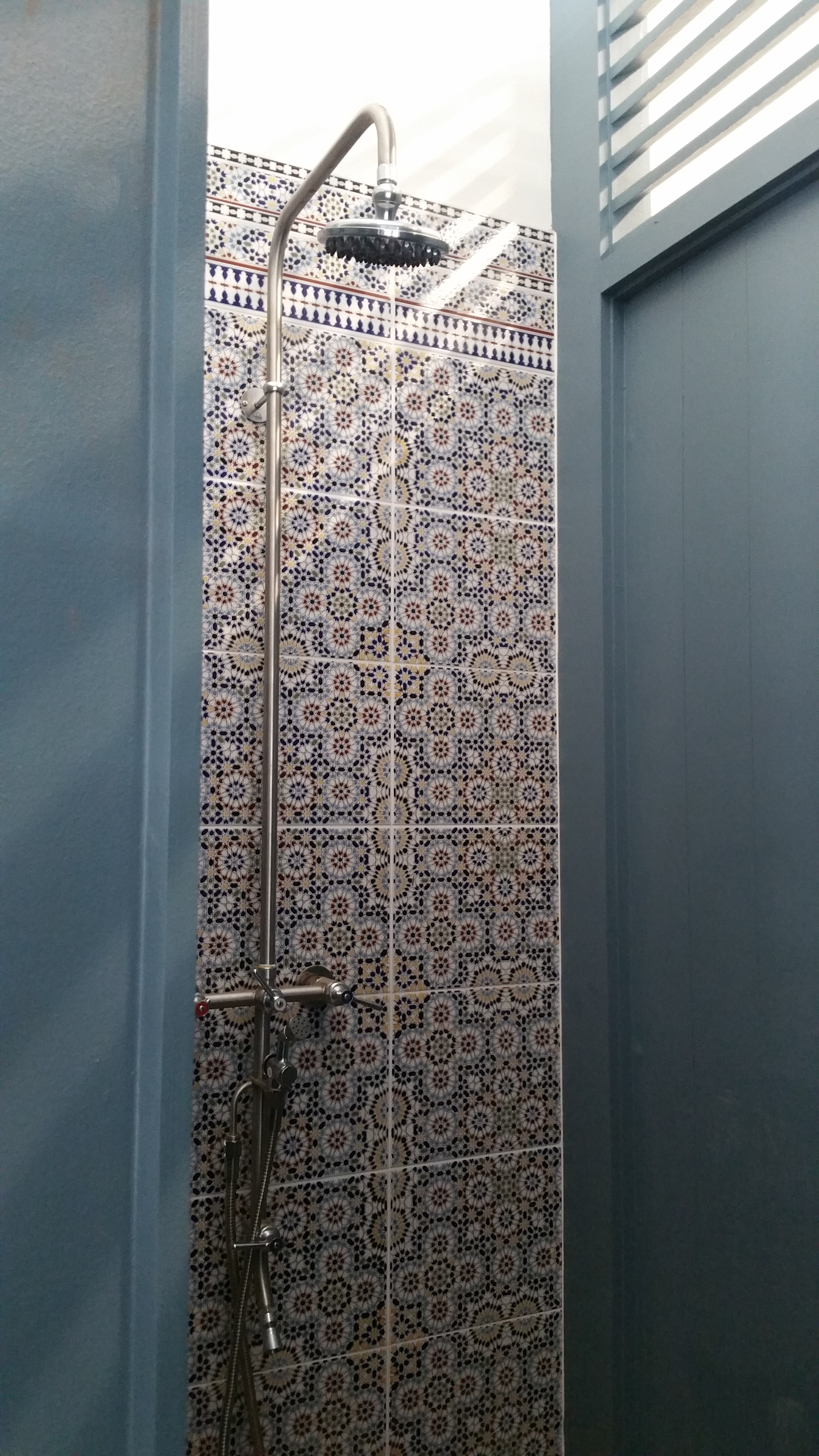 Moroccan tile shower with rain showerhead