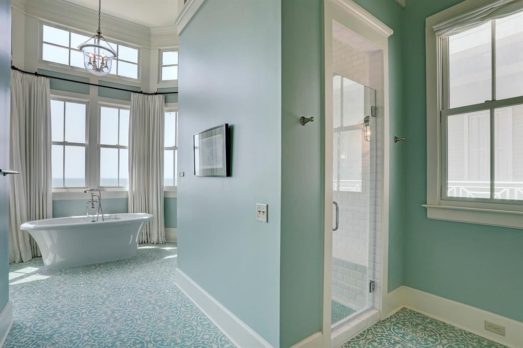 Spa bathroom with seafoam walls and freestanding tub