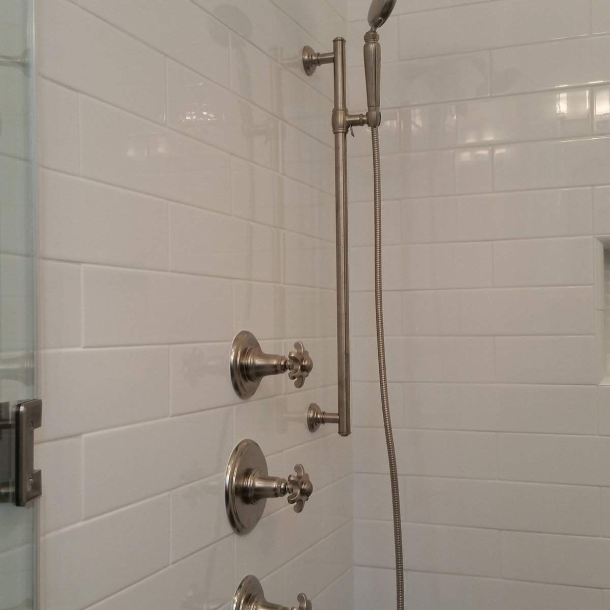 White subway tile shower with cross-handle fixtures