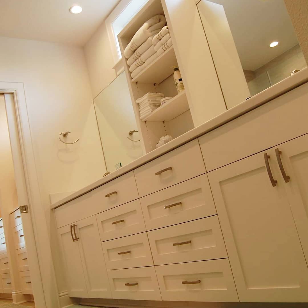 Bedroom with white built-in cabinetry and mirrored doors