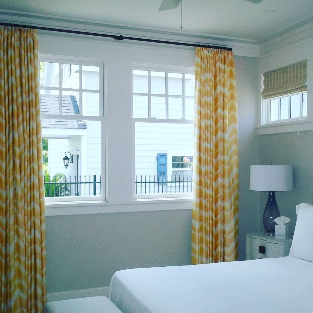 Coastal bedroom with geometric curtains and window seat