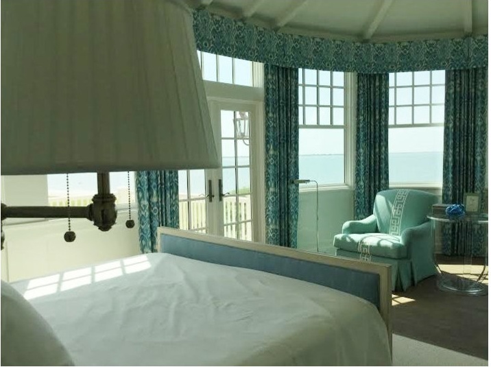 Coastal master bedroom with ocean views and custom treatments