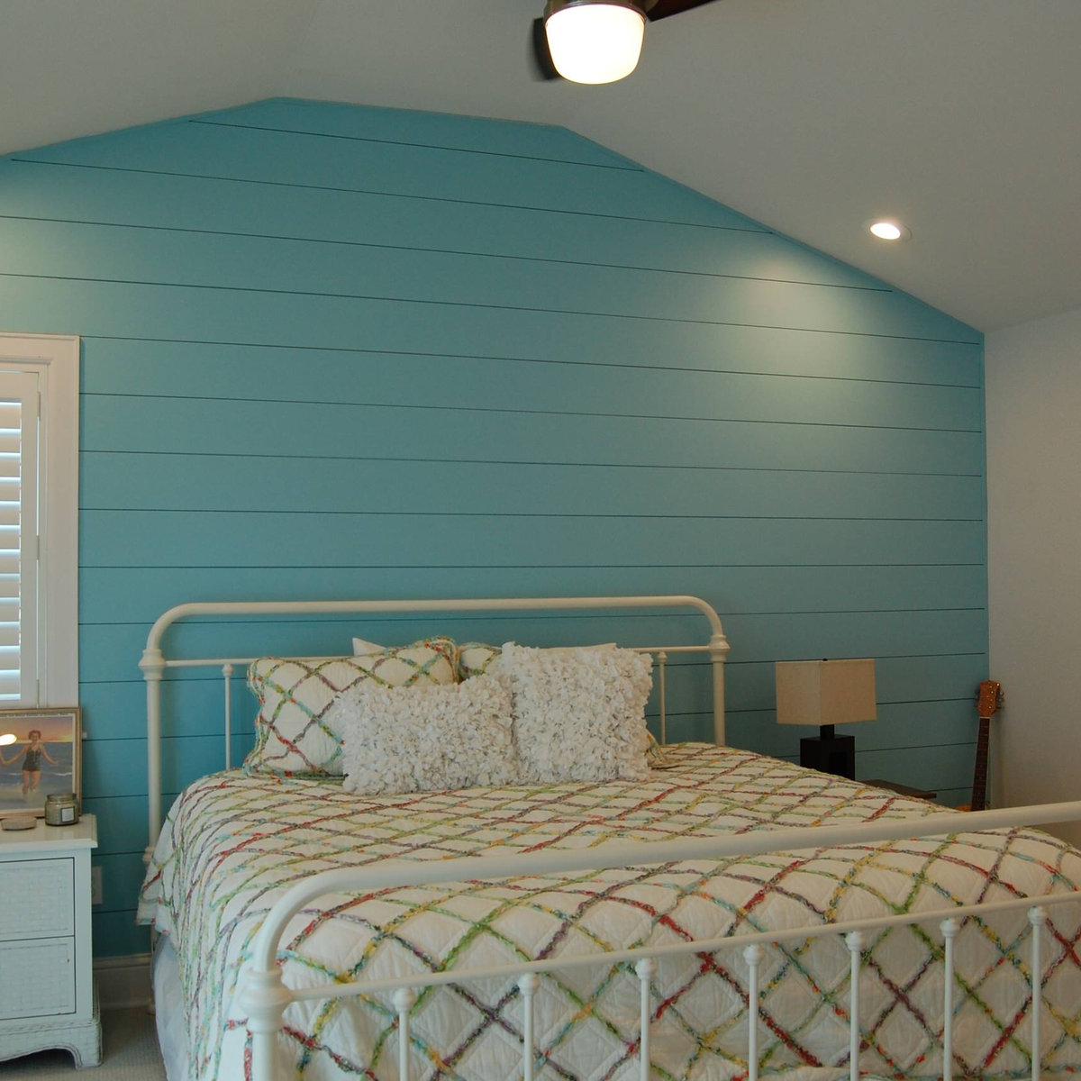 Bedroom with curved turquoise shiplap accent wall