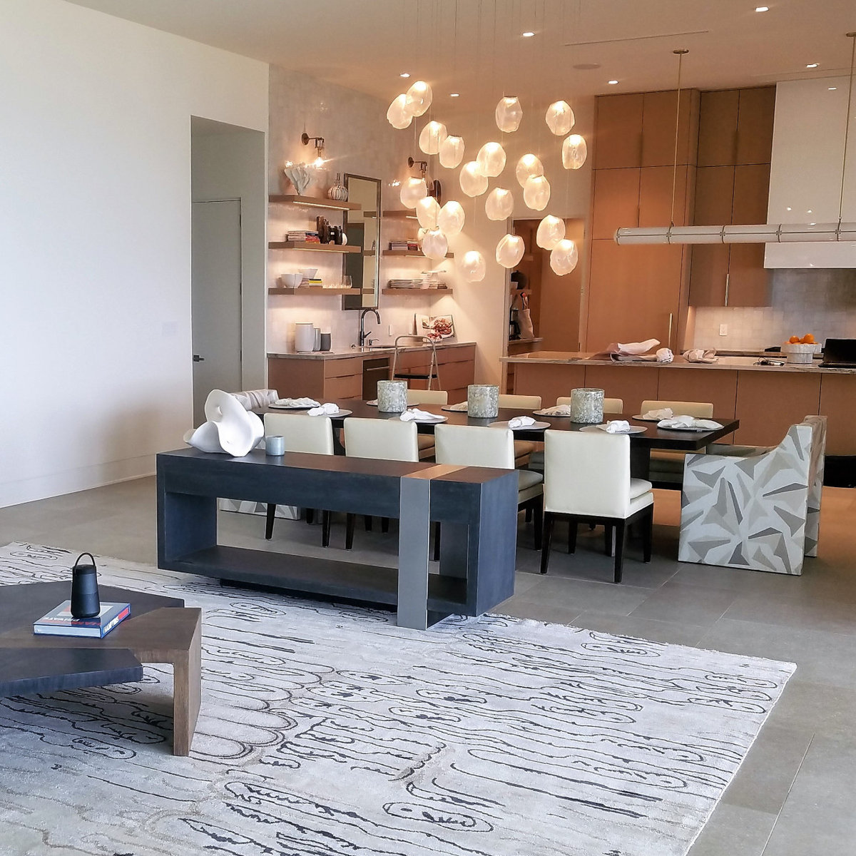 Modern kitchen with sculptural pendant lights and custom cabinetry