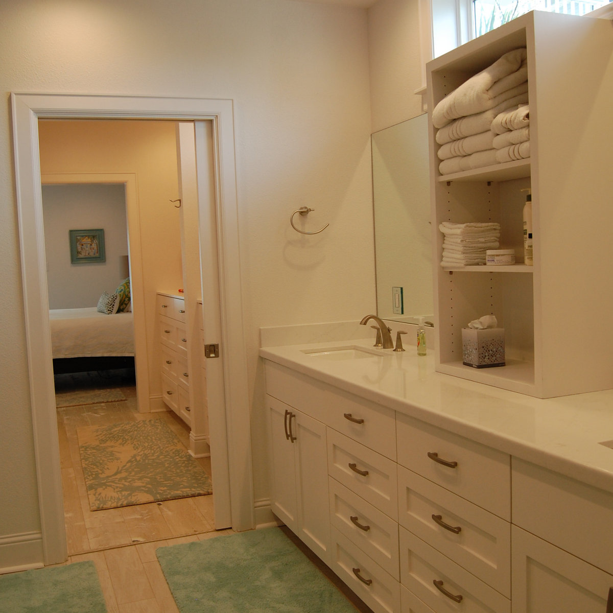 White bathroom vanity with organized open shelving