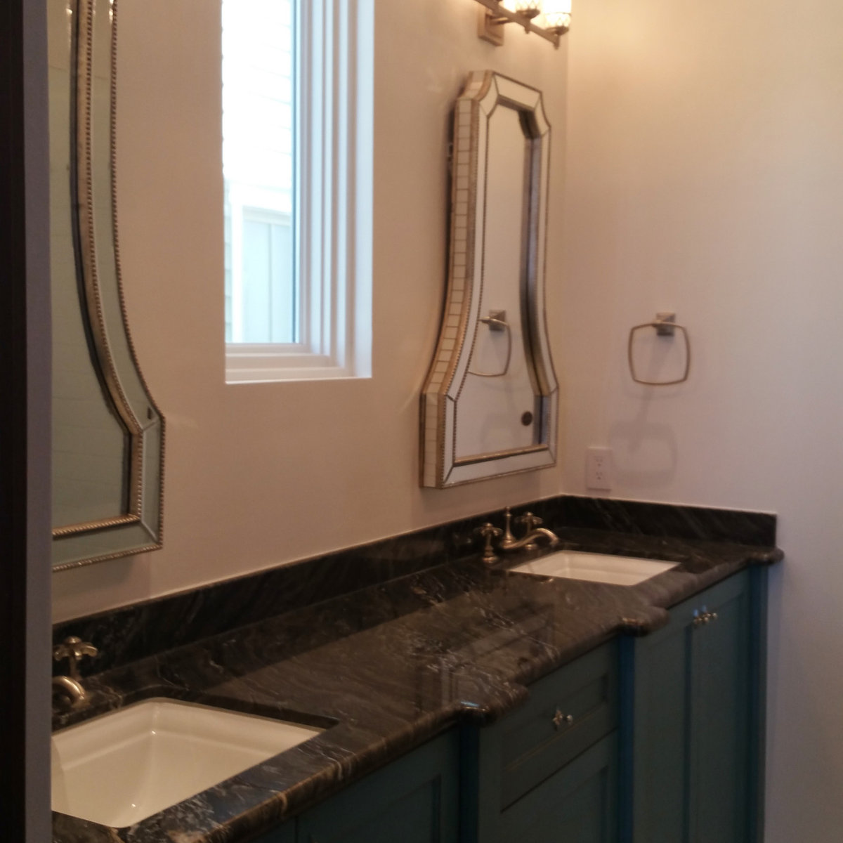 Dual vanity bathroom with black granite and mirrors