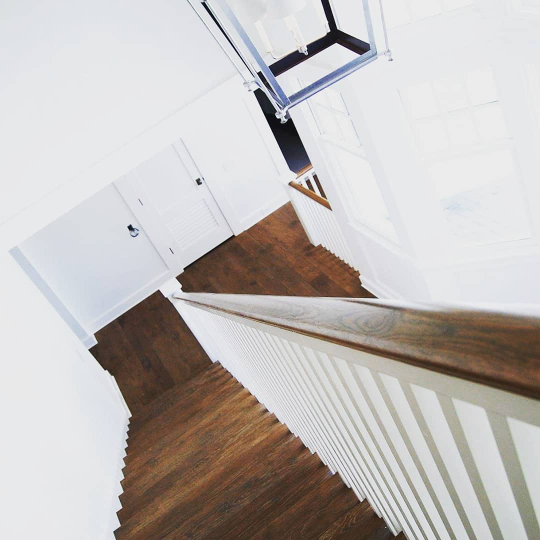 Overhead view of wooden staircase with white treads