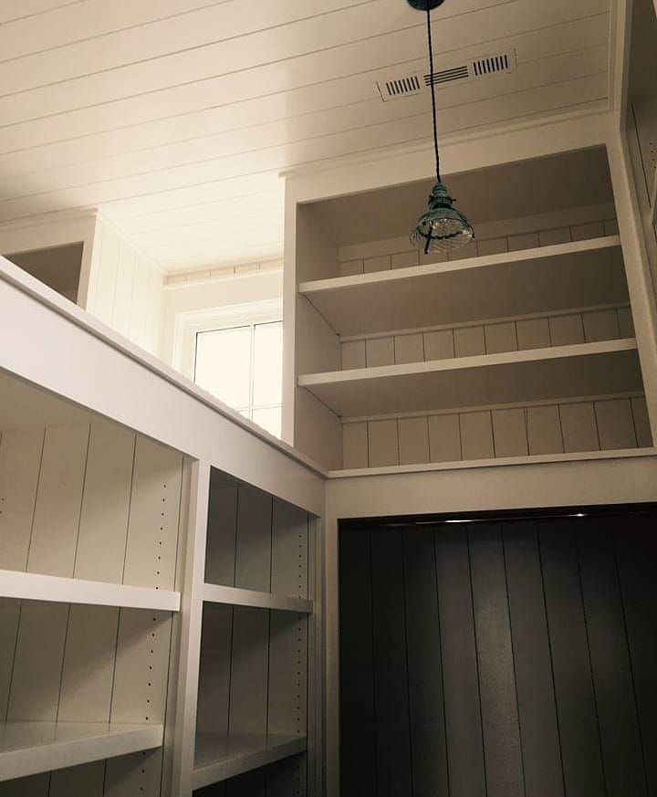 Pantry with shiplap walls and open shelving