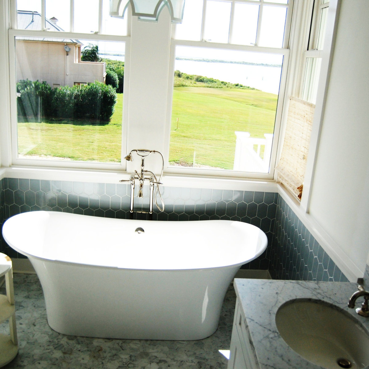 Freestanding tub with green hexagonal tile and views